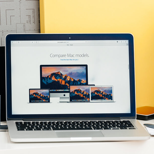 MacBook Pro Retina with OLED touch bar in a geek creative room showcasing new professional laptop 
